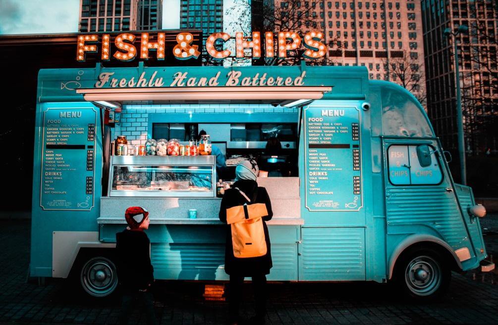 A customized blue food truck specializing in selling fish and chips