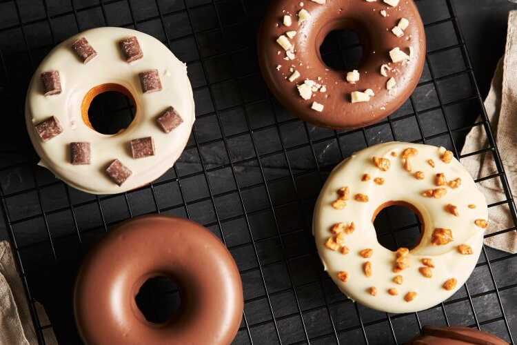 Several pieces of milk and chocolate flavored donuts with decorations