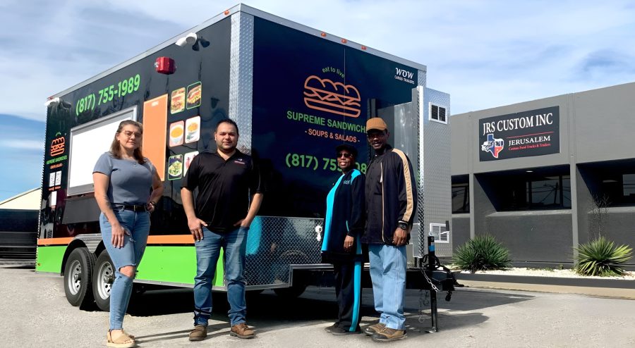 JRS employees and owners of the new Supreme Sandwich food trailer posing in front of the newly completed trailer