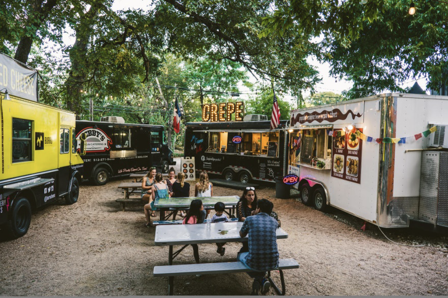 food trailers and trucks gathered together in a food truck park