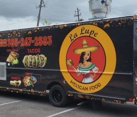 La Lupe Mexican Food truck with a black wrap featuring a large circular logo with a traditional Mexican woman mascot, food photos of tacos, quesadillas, burritos, and tortas, gold food icon border pattern, and to-go order phone number