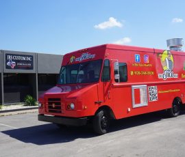 The Taco Man food truck from Berthoud, CO with a bright red wrap featuring a mascot illustration, Colorado logo, social media handles, phone number, and QR code, parked outside JRS Custom Inc in Texas