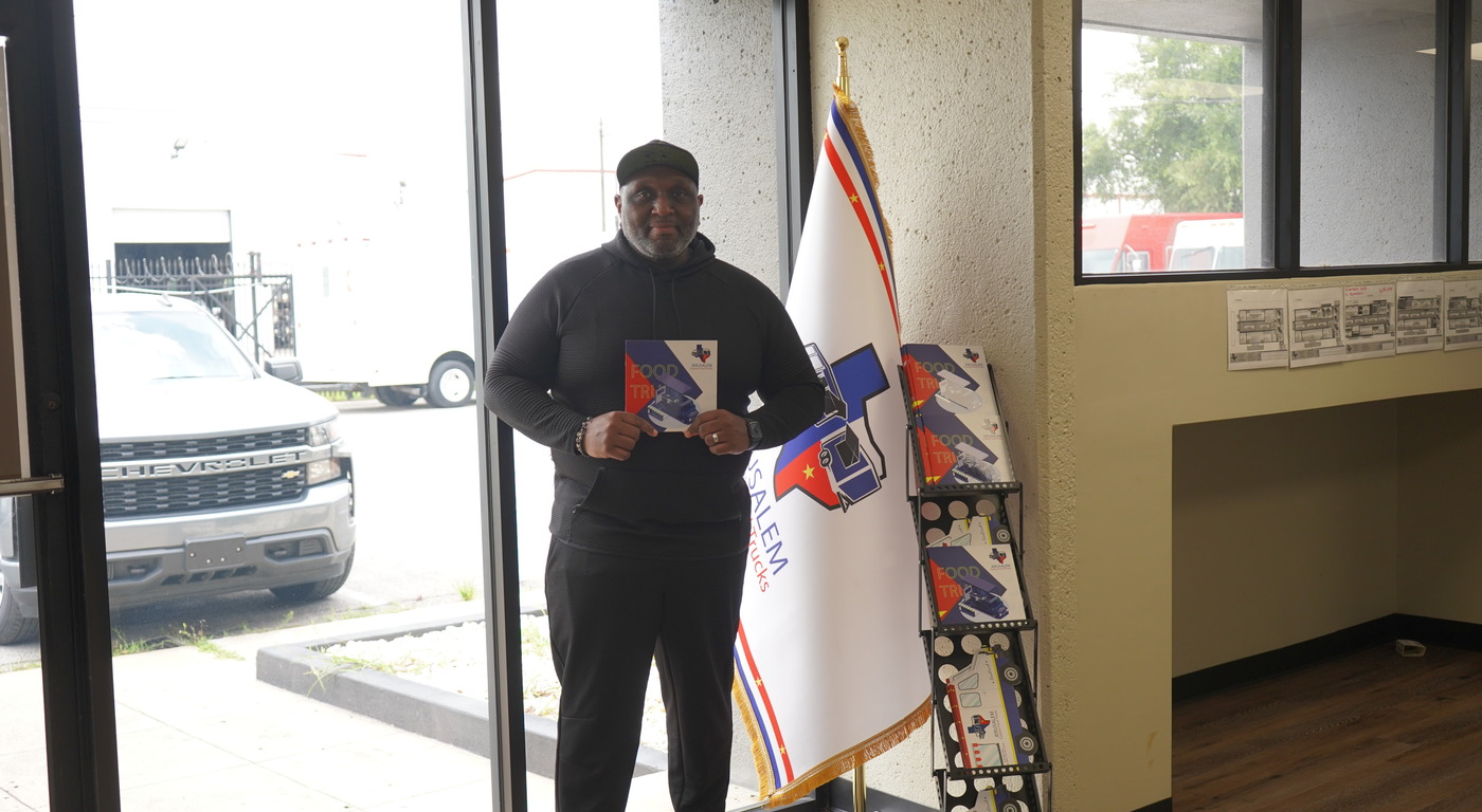 jrs customer standing in the office holding a jrs pamphlet