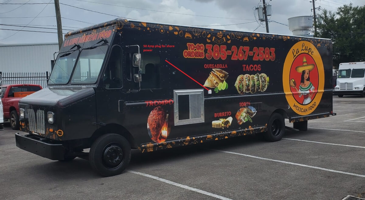 La Lupe Mexican Food truck with full wrap graphics featuring menu items including tacos, quesadillas, and burritos