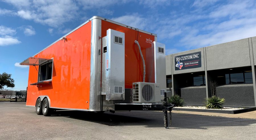 Custom red food trailer with service window parked in front of the JRS Custom Food Trucks and Trailers facility in Houston