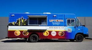 Uptown Burgers & Fish food truck with full-wrap graphics and service window