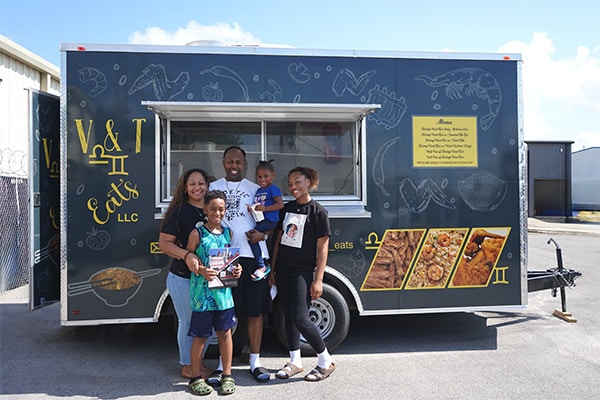 owner with their family in front of the new V and T custom food trailer built by JRS